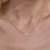 Delicate gold diamond triple heart necklace - sparkling romantic charm on woman's neck