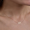 Gold 'Mom' necklace - personalized sentimental jewelry on woman's neck