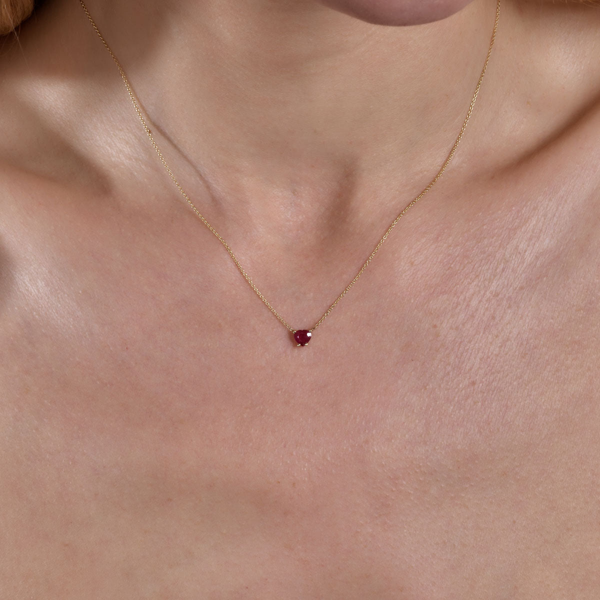 Gold ruby heart necklace on neck - elegant romantic layering jewelry