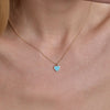 Gold turquoise large heart necklace - bold bohemian pendant adorning model's neck