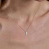 gold turquoise lightning necklace on models neck